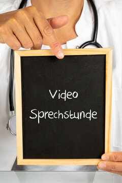 Ärztin in der Praxis mit einer Tafel Video Sprechstunde