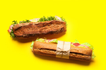 Tasty sandwiches on color background
