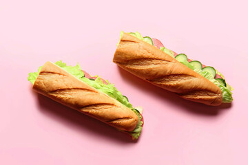 Tasty sandwiches on color background