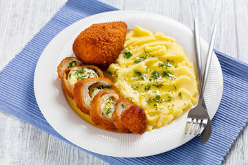 Chicken Kiev served with potato mash on a plate
