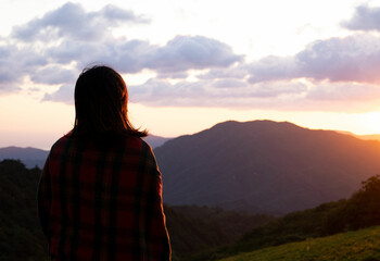 silhouette of a woman in the mountains