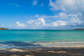 Seven Sea beach in tropical Fajardo Puerto Rico and white puffy clouds
