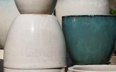 Fototapeta premium Closeup of white and blue ceramic plant pots under sunlight