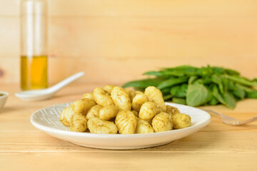 Plate with tasty pesto gnocchi on table