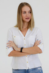 Portrait of One caucasian adult woman with long bronze hair standing, smiling and looking at a camera with self-confident. A woman wears a white shirt and jean shoot white background in a Studio