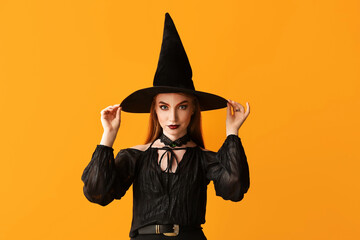 Beautiful woman dressed as witch for Halloween on color background