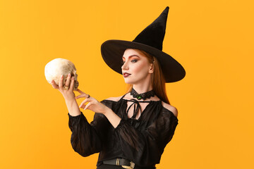 Young witch with skull on color background