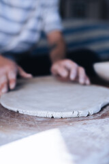 Fototapeta na wymiar Close up of a man making ceramic plate