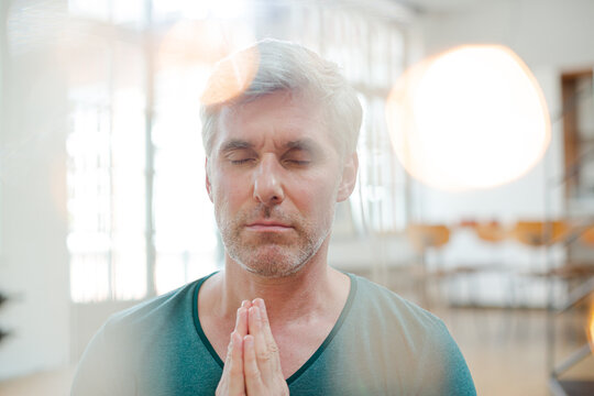 Close up of older man meditating - Powered by Adobe
