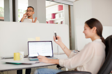 Woman using cell phone in office