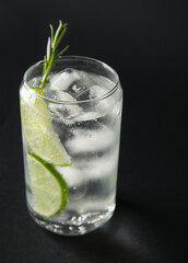 Glass of cold gin and tonic on dark background