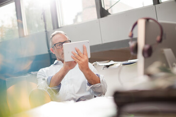 Businessman using digital tablet at office desk