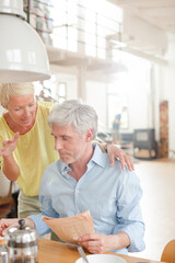 Older couple hugging with coffee cup