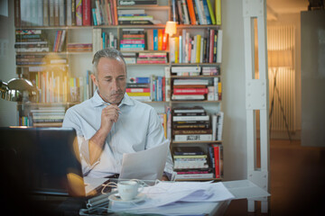 Businessman working on laptop in home office