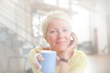 Older woman drinking cup of coffee