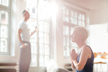 Older woman meditating on floor