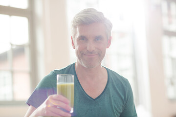 Older man drinking glass of juice