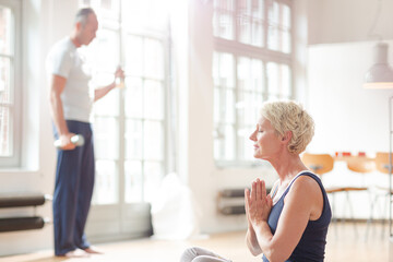 Older woman meditating on floor