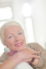 Obraz na płótnie Canvas Older woman smiling on sofa