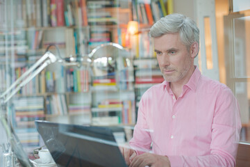 Businessman using laptop in home office