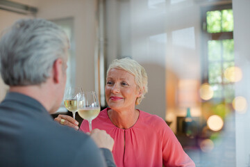 Older romantic couple drinking white wine