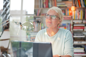 Businesswoman smiling at computer in home office