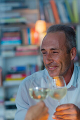 Older man drinking white wine