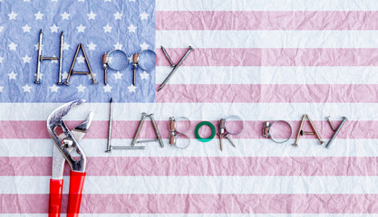 Happy Labor day card idea background, spare part and tool arrange in letter on white wrinkle  paper texture background