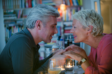 Close up of romantic older couple holding hands