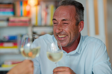 Older friends drinking white wine