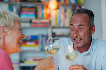 Older friends drinking white wine