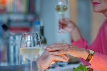 Close up of romantic older couple holding hands