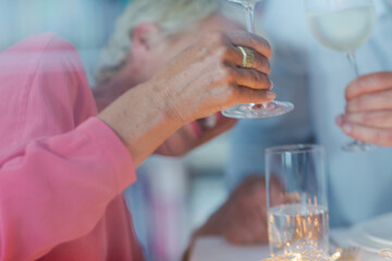 Older woman drinking glass of white wine