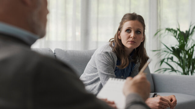 Depressed Woman Sitting On The Therapist Couch