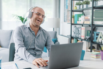 Happy remote worker connecting with his laptop