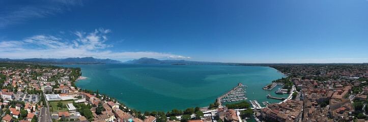 Aerial panorama of the town of Desenzano del Garda on Lake Garda in Italy. Top view of the boat parking on the lake. Italian resorts on Lake Garda. Aerial view of Desenzano del Garda.