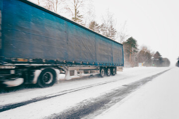 A moving truck on the highway in winter.