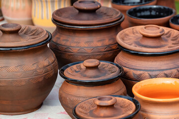 Fototapeta na wymiar Set of handmade clay pots on the diy fair counter