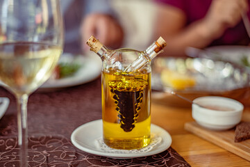 Glass on a high thin leg with white wine in a restaurant