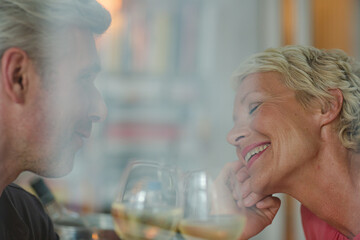 Older romantic couple drinking white wine