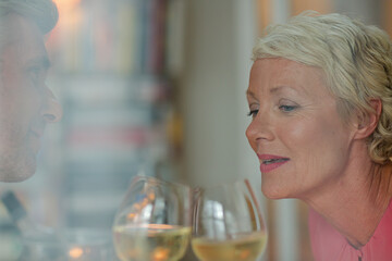 Older romantic couple drinking white wine