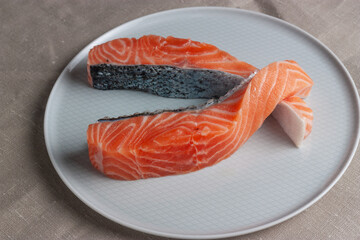 Lomos de Salmón crudo en plato blanco. Concepto gastronomía minimalista.