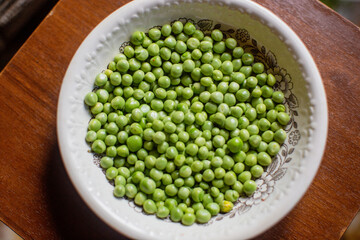 Fresh peeled green peas are in a plate