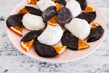 vegan almond crescent cookies and dehydrated orange slices covered in dark chocolate, healthy plant-based food