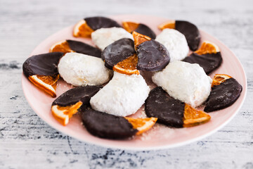 vegan almond crescent cookies and dehydrated orange slices covered in dark chocolate, healthy plant-based food