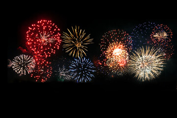 Multi colored fireworks in a black background.