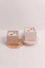 scented candles on off white background in rock holder