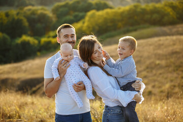 Fototapeta premium family with small children in the background of nature