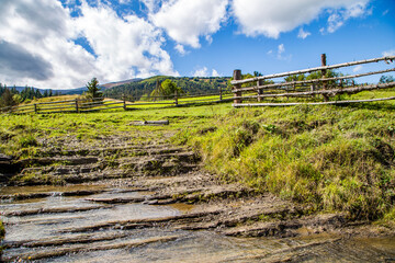 mountain stream in the countryside on a background of mountains.