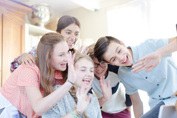 Obraz na płótnie Canvas Group of teenagers waving while communicating via internet